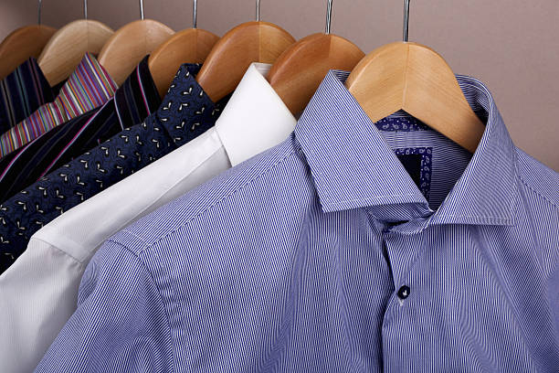 istock Shirts hanging on wooden coat hangers 621820316