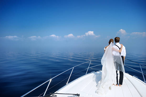 istock Happy bride and groom on a yacht 621820634