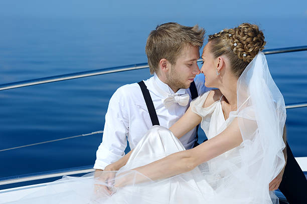 istock Happy bride and groom on a yacht 621820688