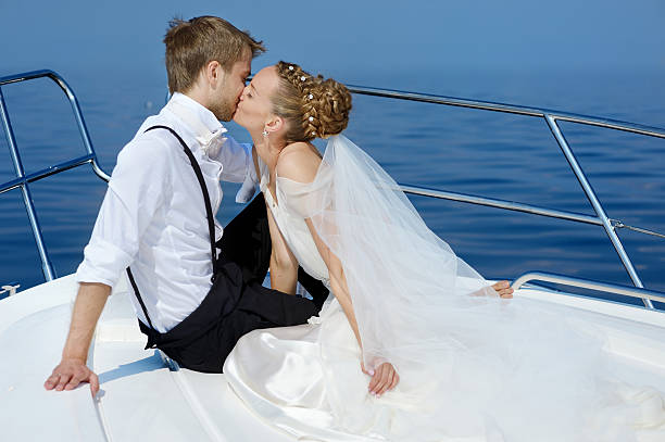 istock Happy bride and groom on a yacht 621820746