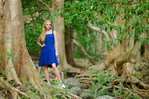 Young beautiful woman in a tropical jungle