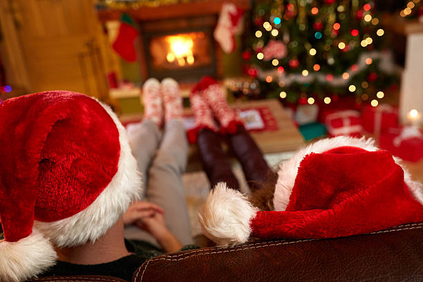 istock Couple with Santa Claus hats 621821360