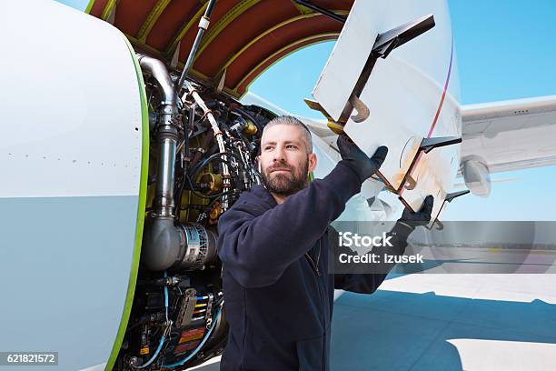 Aircraft Mechnic In Front Of Aircraft Engine Stock Photo - Download Image Now - Adult, Air Vehicle, Airfield