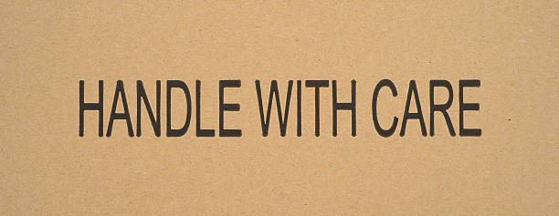 istock Handle with care sign printed on cardboard 621822370