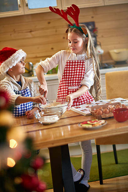 istock smiling children making Christmas cookies 621823088