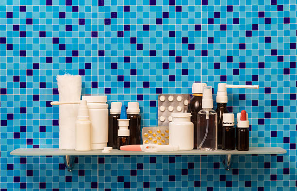 istock Shelf with pregnancy test, medication, pills, bandage on abstract blue. 621823198