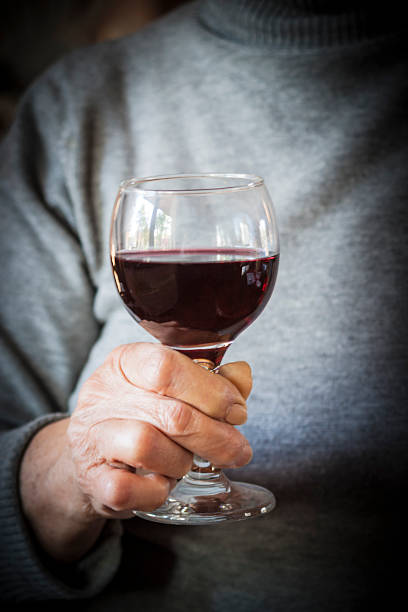 istock Hand holding a glass of red wine 621823512