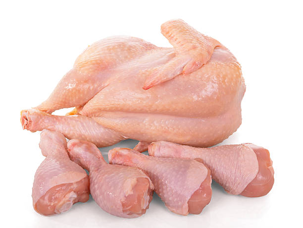 istock Whole raw chicken carcass and legs isolated on white. 621823762