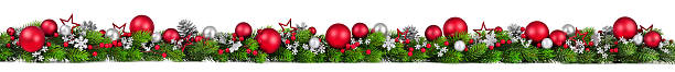 Christmas border on white, extra wide Extra wide Christmas border with fir branches, red and silver baubles, pine cones and other ornaments, isolated on white floral garland stock pictures, royalty-free photos & images