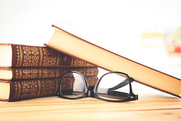 istock reading glasses with books on the table 621824488