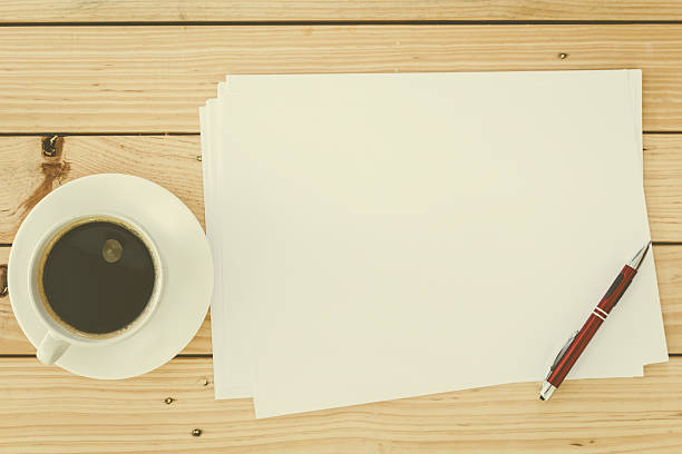 istock Blank paper page and cup coffee  with pen 621825050
