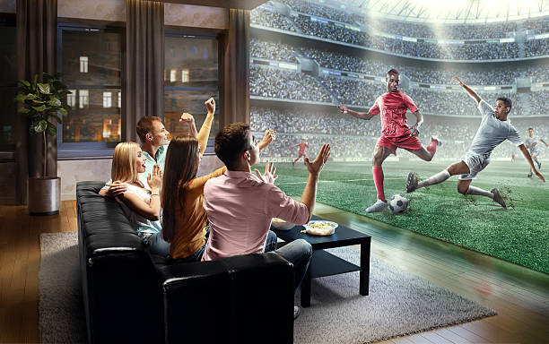 students watching very realistic soccer game on tv - soccer stadium fotografia de stock imagens e fotografias de stock