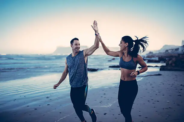 Photo of Fitness Couple giving each other high five after hard training
