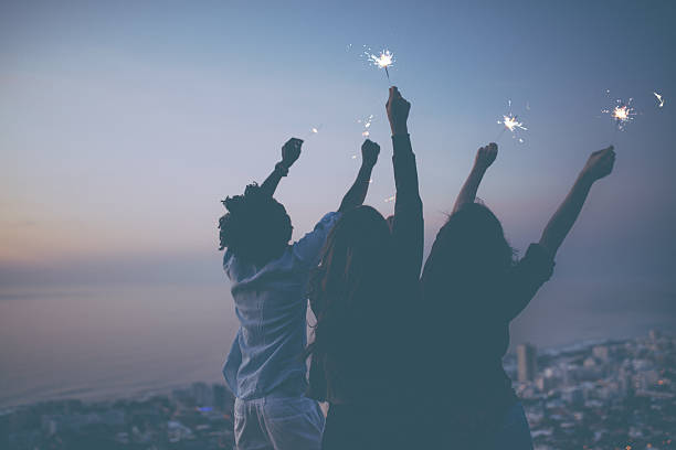 istock Friends celebrating with sparklers at sunset 621830738