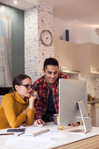 istock Man and his young wife going through their financials 621832924