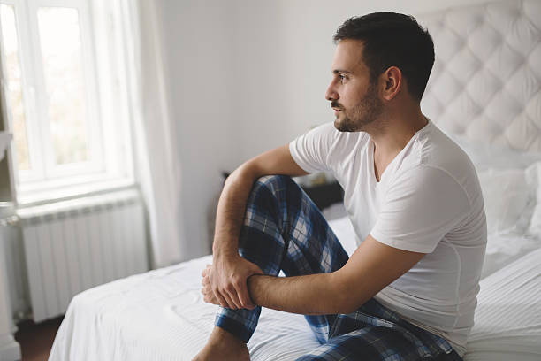 istock Lonely man in pajamas 621834738