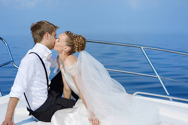 istock Happy bride and groom on a yacht 621835314
