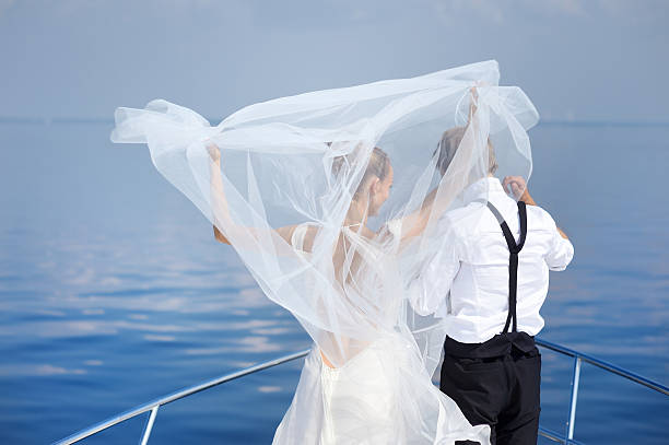 istock Happy bride and groom on a yacht 621835376