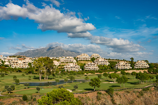 Exclusive Spanish holiday apartments on the Costa del Sol, Spain with golf course in foreground. Marbella