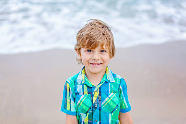istock little kid boy on the beach of ocean 621836280