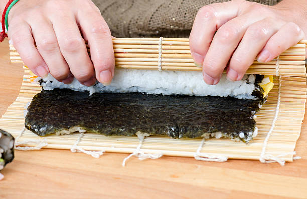 istock Woman making california roll, 621837646