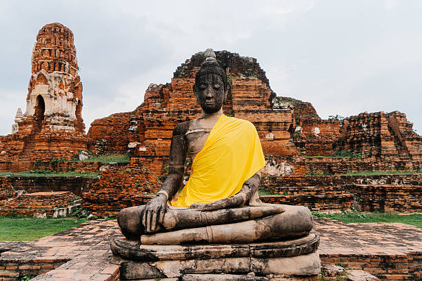 istock Buddha statue in the ruined ancient temple 621837908