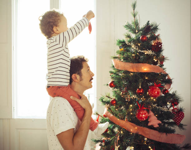 istock Father and son decorating the Christmas tree 621838086