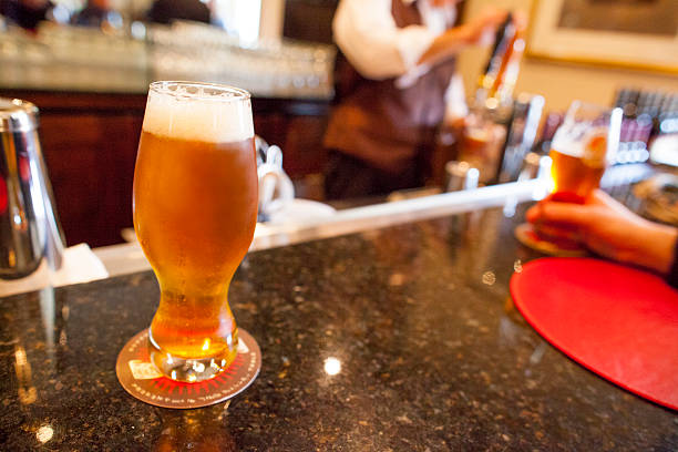 Glass of freshly poured draft beer on bar