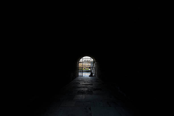 istock People silhouette in dark tunnel 621840536