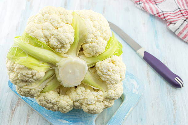 istock Raw cauliflower on a wooden table 621841084