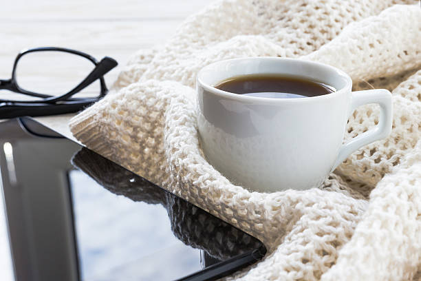 istock Warm knitted plaid, glasses, coffee and tablet 621841196