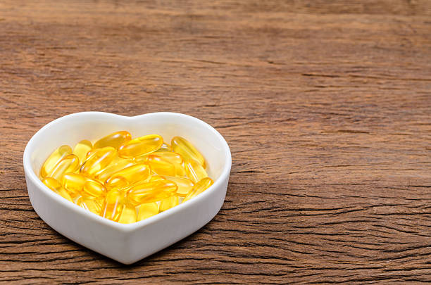 istock fish oil in heart shape bowl 621841874