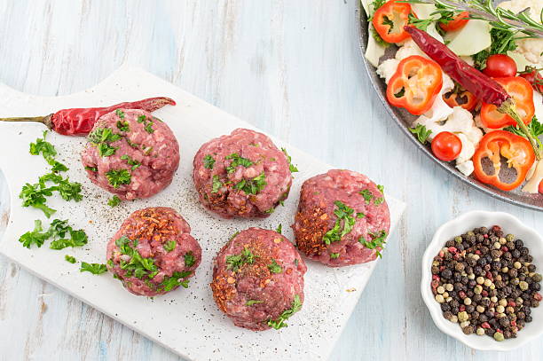 istock Raw meatballs ready for frying on a tray 621842336