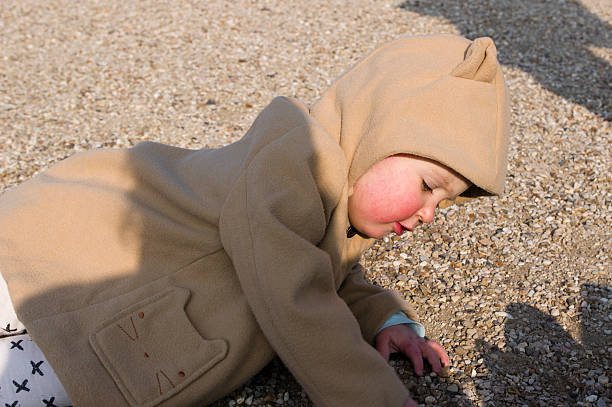 istock Baby girl playing on the ground 621842728