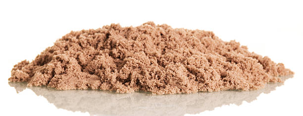 istock Kinetic sand in pile closeup isolated on white background. 621844592
