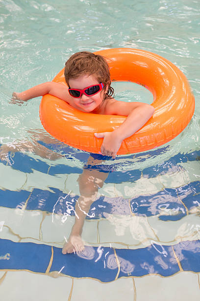 istock Smiling boy enjoying in swimming pool. 621844602