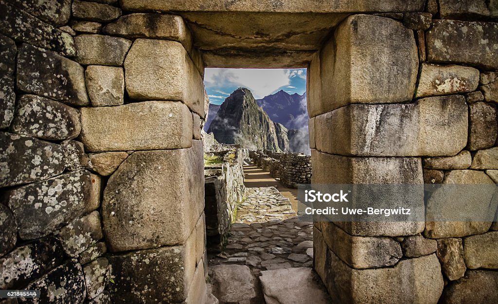 Machu Piccu View of huayna Picchu through a stone gate of Machu Piccu Machu Picchu Stock Photo