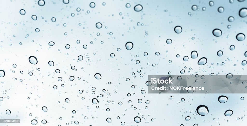 Drops of rain on glass Drops of rain on glass , rain drops on clear window / rain drops with clouds / water drops on glass after rain background / water drops / Small water drops on the glass Lightweight Stock Photo