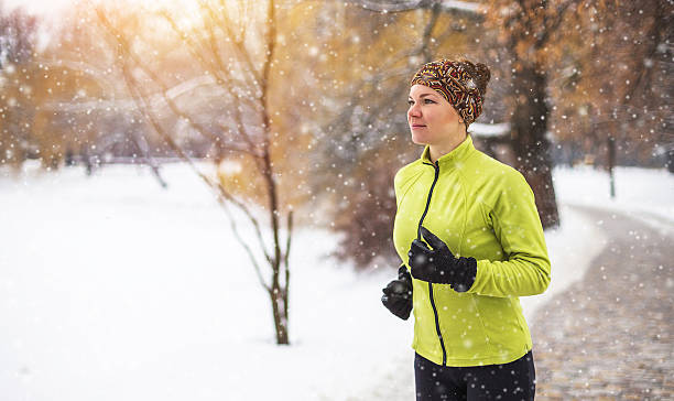 Young sport woman doing exercises during winter training outside in stock photo