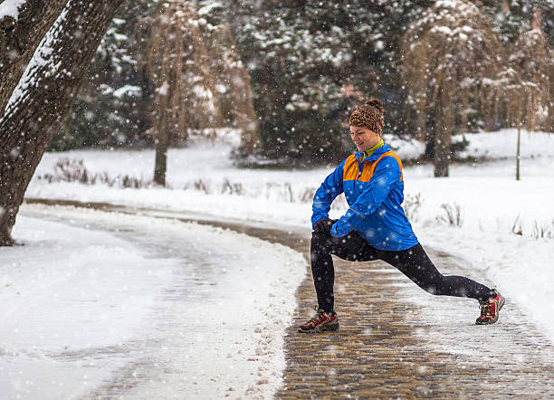 istock Young sport woman doing exercises during winter training outside in 621847970