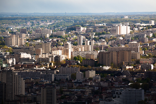 Paris high rise suburbs in bright evening sun aerial view