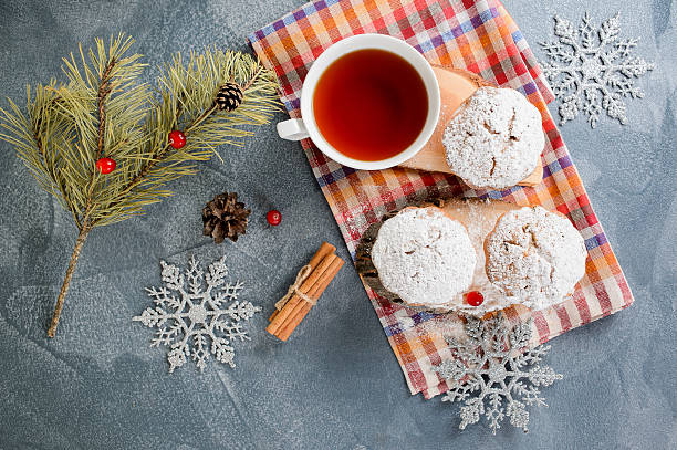 istock Fresh homemade cranberry muffins in icing sugar with fir-tree branches 621849062