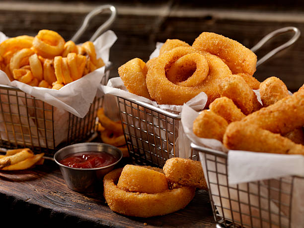 baskets of onion rings, curly fries and cheese sticks - lökring bildbanksfoton och bilder