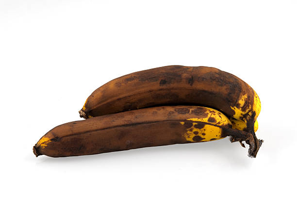 istock brown overripe bananas on white background 621849716