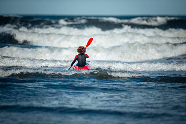 female kayaking in the sea - ankle deep in water imagens e fotografias de stock