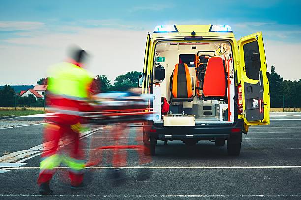 Emergency medical service Emergency medical service. Paramedic is pulling stretcher with patient to the ambulance car. emergency medicine stock pictures, royalty-free photos & images
