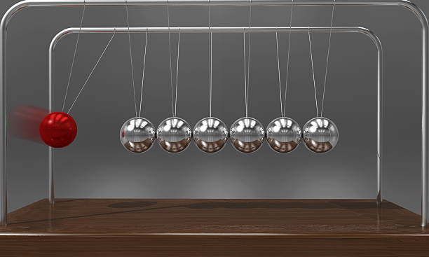 istock Balancing ball Newton's cradle pendulum with motion blur 621851788