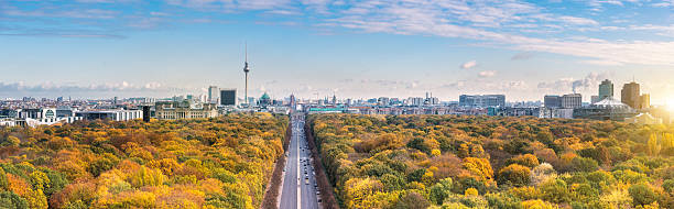wide Berlin skyline over autumn colored  Tiergarten wide colorful autumn Berlin cityscape panorama from victory column brandenburg gate photos stock pictures, royalty-free photos & images