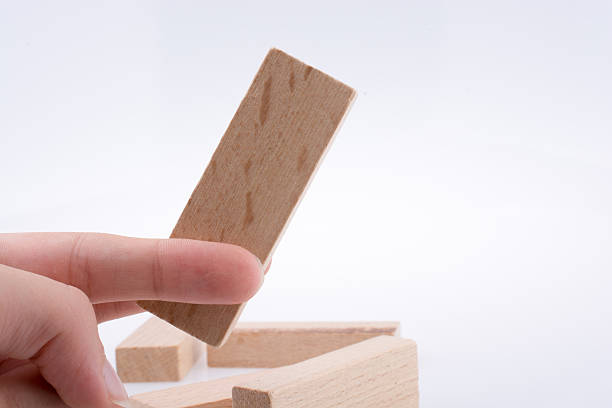 istock Hand playing with wooden building blocks 621853440