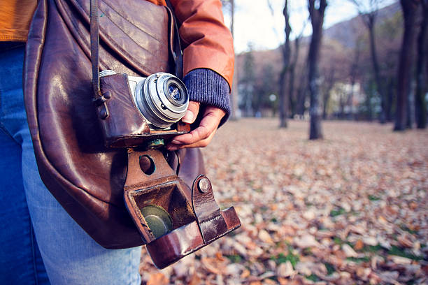 istock Vintage camera with leather bag hold woman hand 621853994